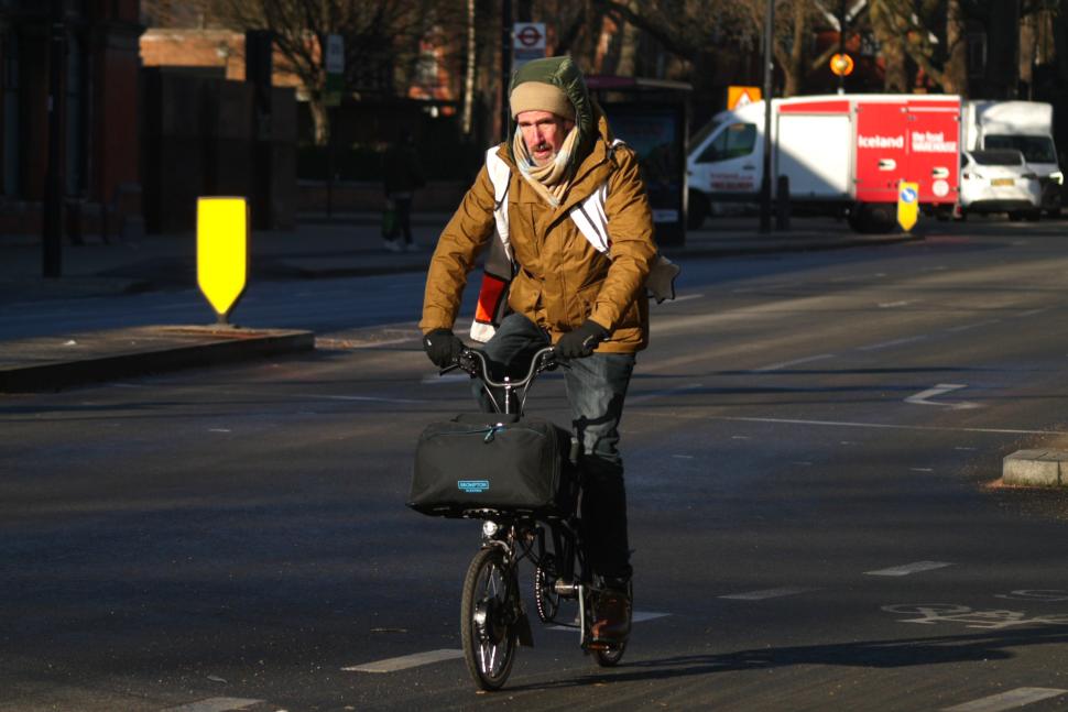 Cyclist in London electric Brompton and winter clothing - copyright Simon MacMichael