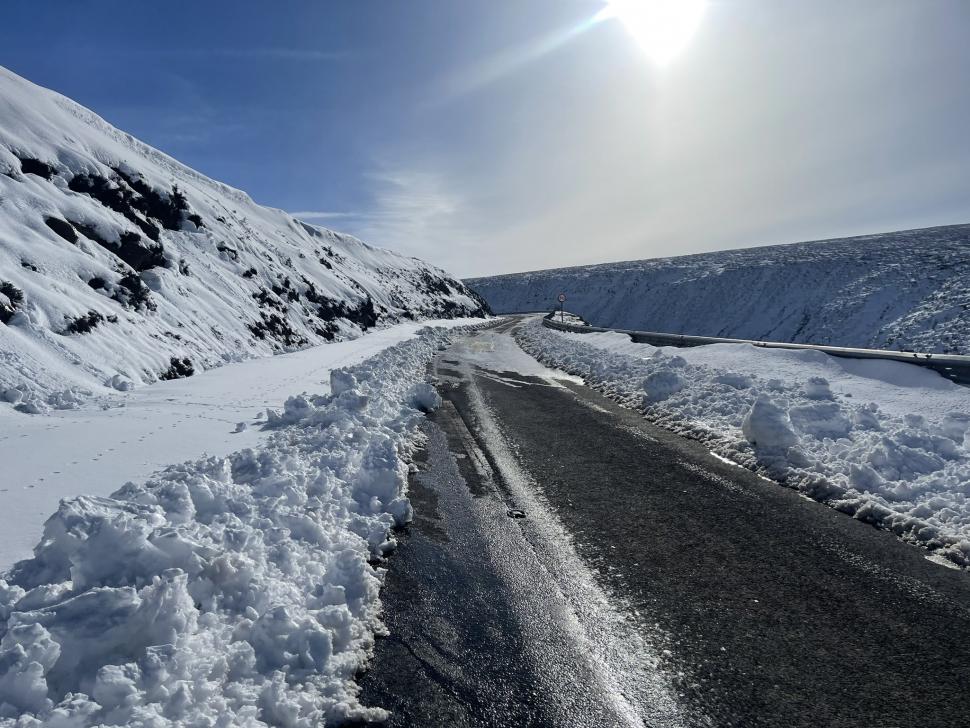 Peak District or the Alps Cyclist enjoys snow covered Snake Pass