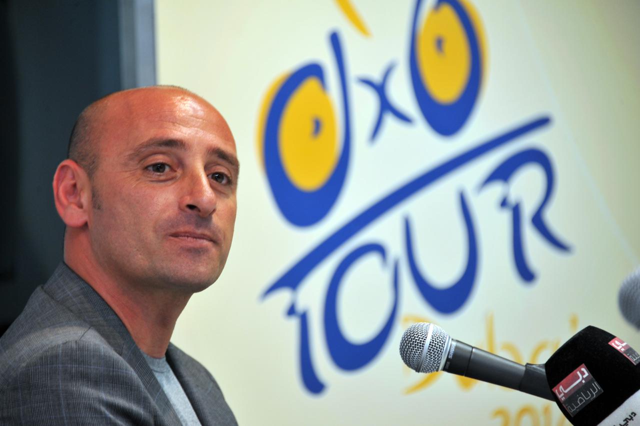 Italy's Olympic champion Paolo Bettini, left, looks at his