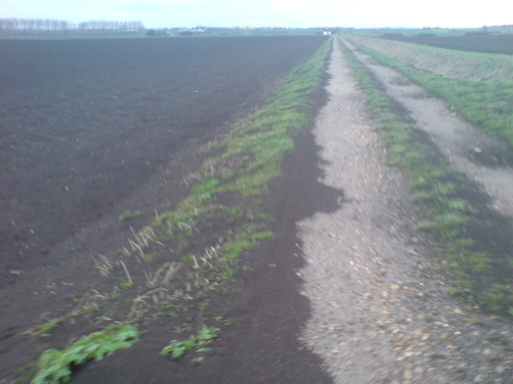 The topsoil blows onto the road in the recent storms