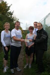 Phil England of Maiden Newton Running Club presents cheque to Peter Henshaw of Sustrans.JPG