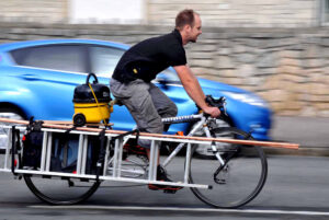 Plumber Chris Jones on his bike (picture credit Dorset Media Service).jpg