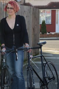 Charlotte and two of her retrieved bikes.JPG