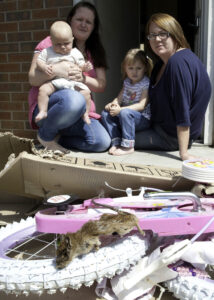 Lindsey Rhodes with her son Malakai daughter Mia godmother Lauren Ingle and the decomposed rat found dead in the packaging pic courtesy The Star.JPG
