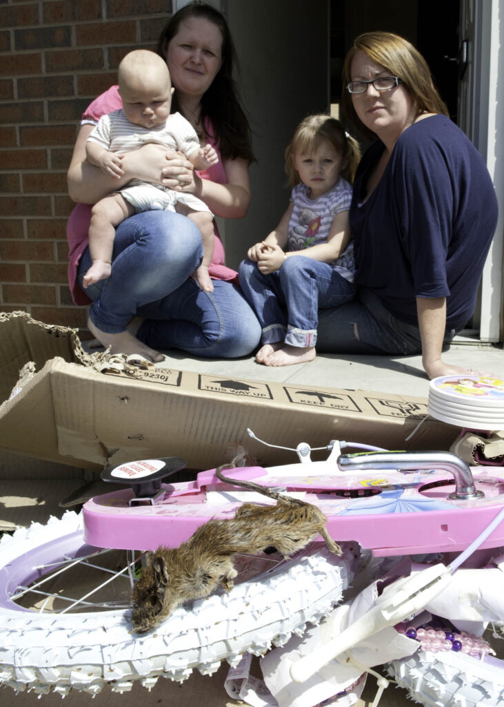 Lindsey Rhodes with her son Malakai daughter Mia godmother Lauren Ingle and the decomposed rat found dead in the packaging pic courtesy The Star.JPG