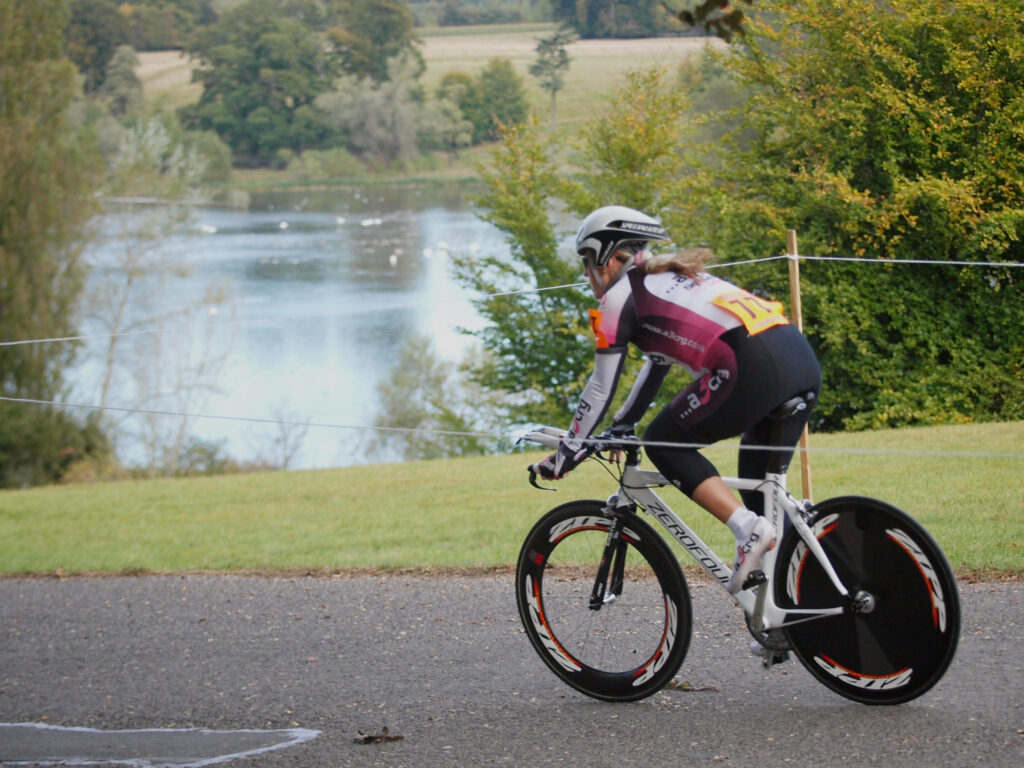Competitor passes the lake  in the Bike Blenheim Palace women’s time trial