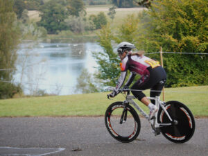 Competitor passes the lake  in the Bike Blenheim Palace women&rsquo;s time trial