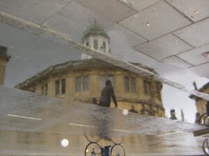 Bike passing Sheldonian Theatre, Oxford.jpg