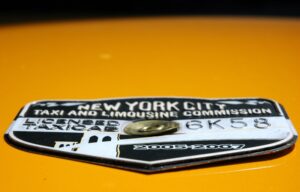 NYC taxicab medallion (CC licensed by Danielle Lupkin, Wikimedia Commons)