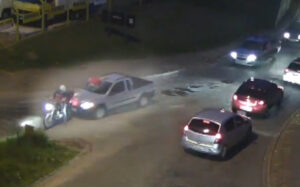 A motorcyclist attempts to stop the car with the rider’s body embedded in the windcsreen