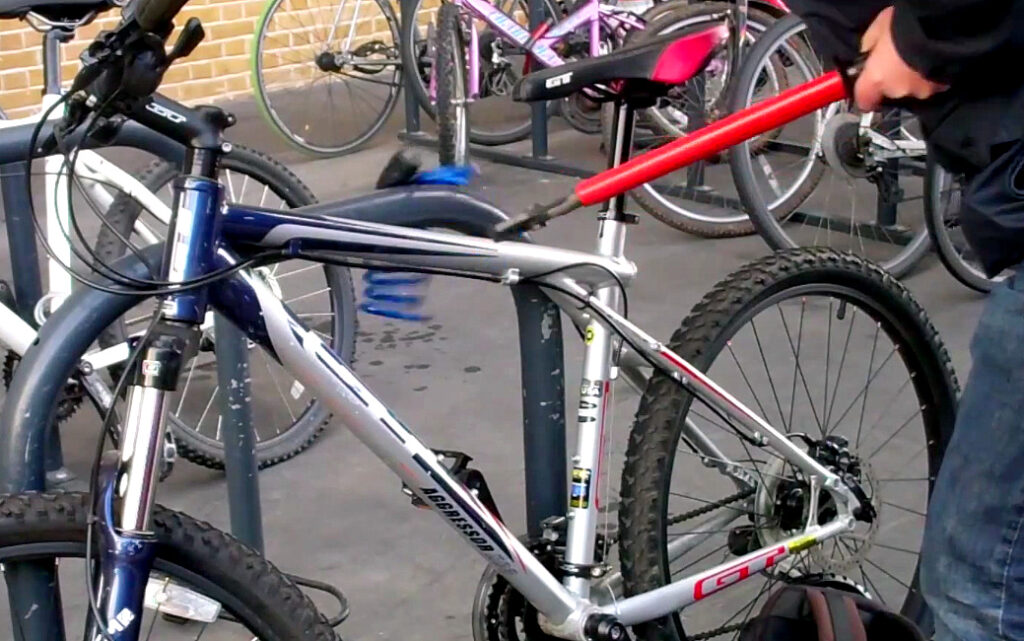 A BTP officer shows how easy a cheap lock is to cut