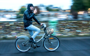A Velib rider on the Pont des Arts (BY-SA licensed by Jean-Francois Gornet:Flickr)
