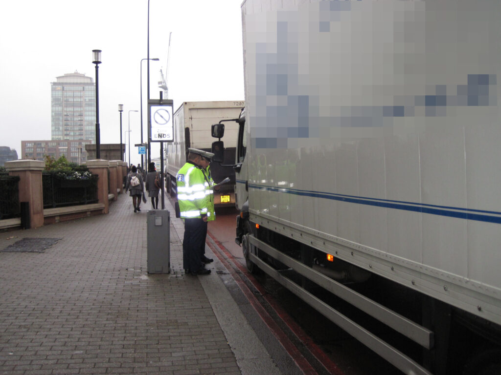 Metropolitan Police officers inspecting a lorry