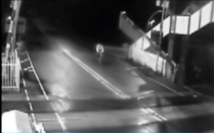 Cyclist approaching closing level crossing.png