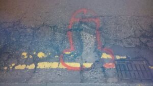 Pothole penis graffiti (source Wanksy Facebook page)