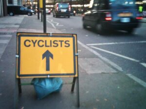 Cyclists sign and London cab (copyright Simon MacMichael)