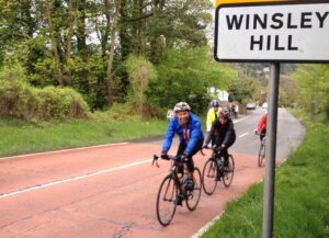 Justin Gage smiling as he climbs Winsley Hill (©Tomas Buxton:Twitter)