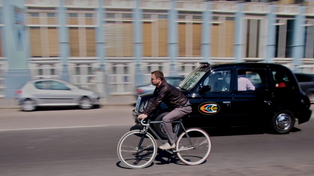 Taxi and Cyclist copyright Simon MacMichael.jpg