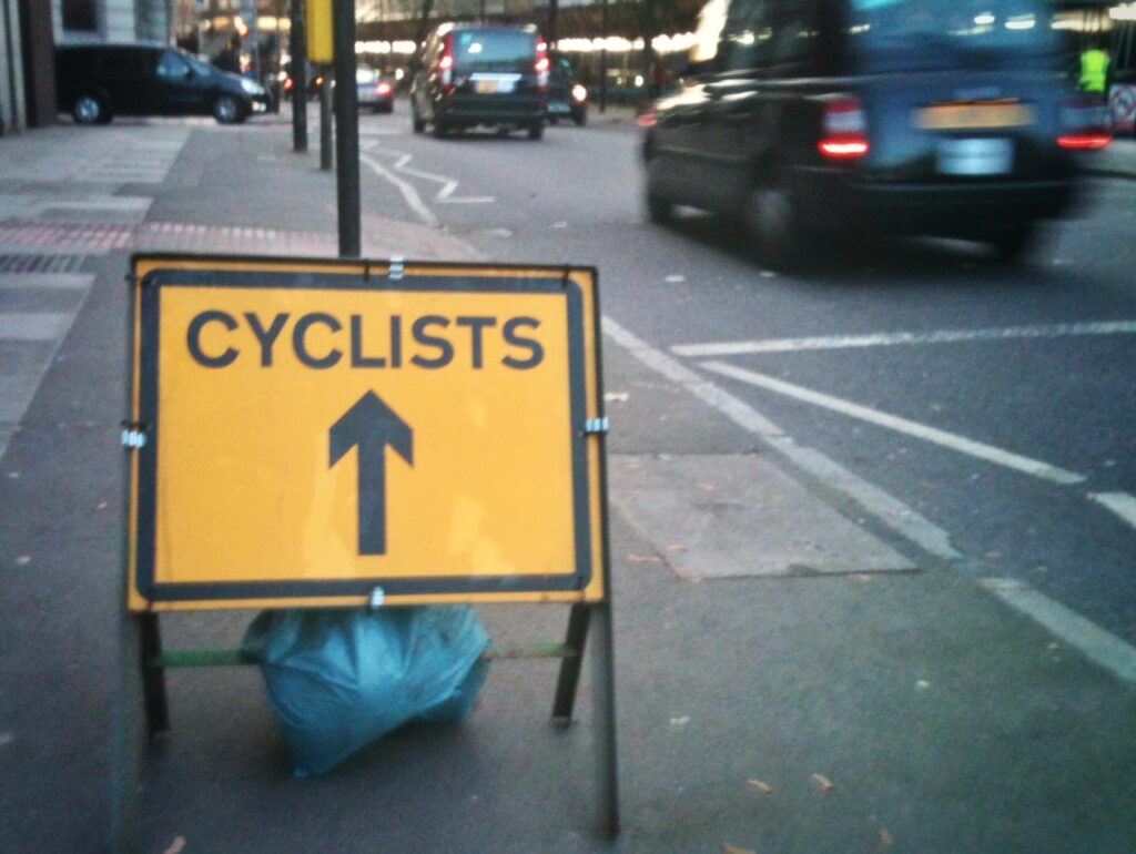 Cyclists sign and London cab (copyright Simon MacMichael)