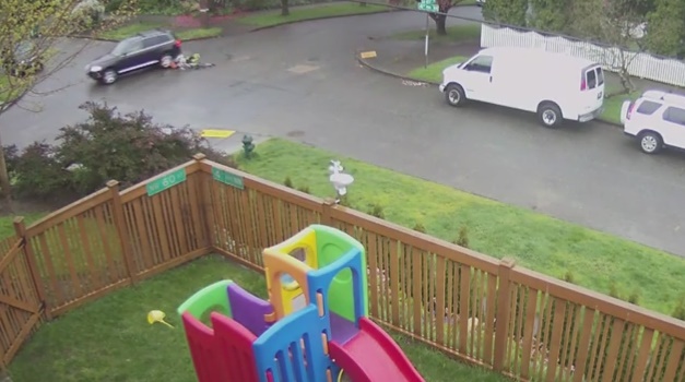 Cyclist skids to avoid SUV (via YouTube).jpg