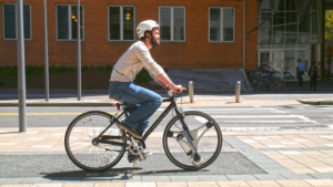 GeoOrbital CTO Dakota Decker using company’s electric front wheel (source Kickstarter).png