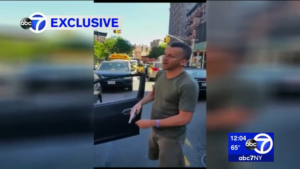 Still from Eyewitness news cop pulls gun on cyclist