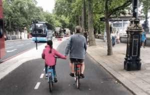 Girl holding hands with dad on Cycle Superhighway (source BikesandBabies on Twitter).PNG