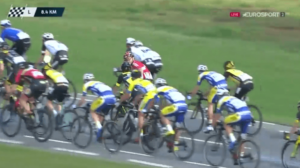 Kris Boeckmans, in the red of Lotto-Soudal, pushes Justin Jules to rear of peloton (Eurosport video still).PNG