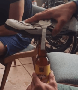 Kristof Allegaert  opening beer bottle (source Juliana Buhring Facebook voide still).PNG