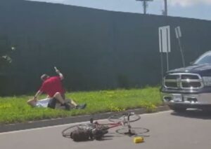 Pick-up truck driver beats cyclist with club.JPG