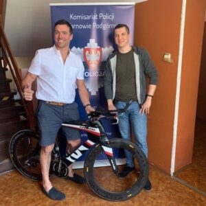 Marc London (left) with Polish police officer and his bike