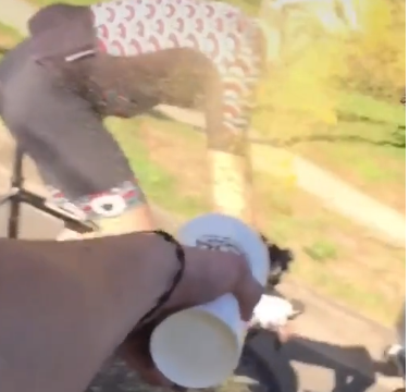 Passenger throws orange juice at cyclist TikTok video still.PNG