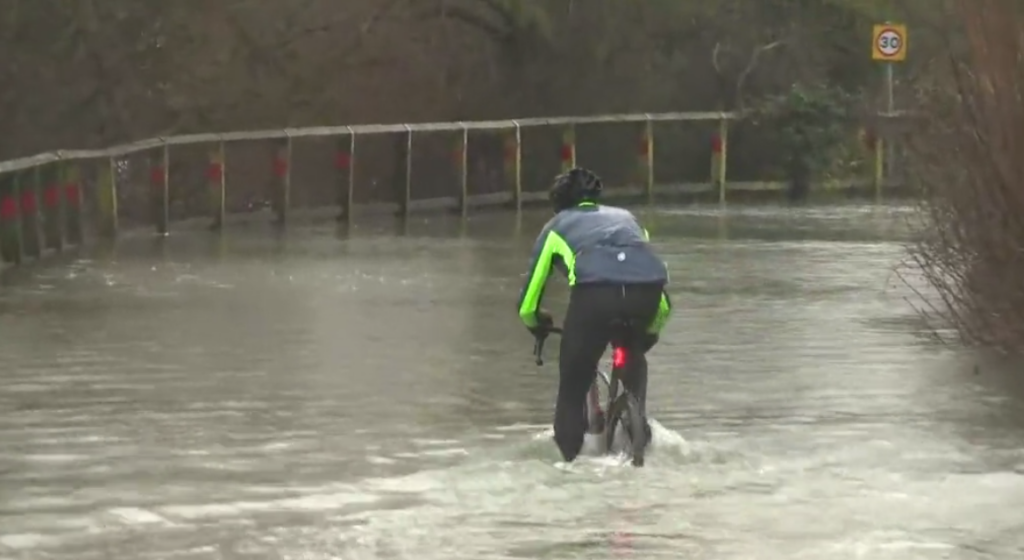 Cyclist rides through flood in York