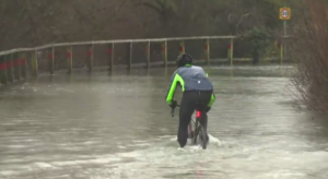 Cyclist rides through flood in York