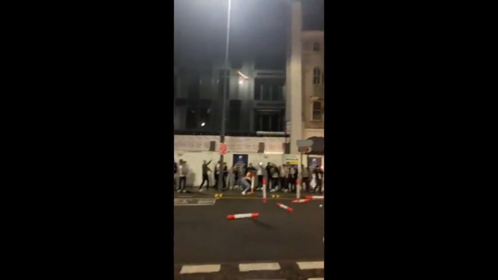 England fans in Leicester chuck bike lane wands.PNG