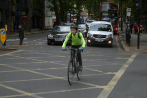 Cyclist crossing box junction (copyright Simon MacMichael).PNG
