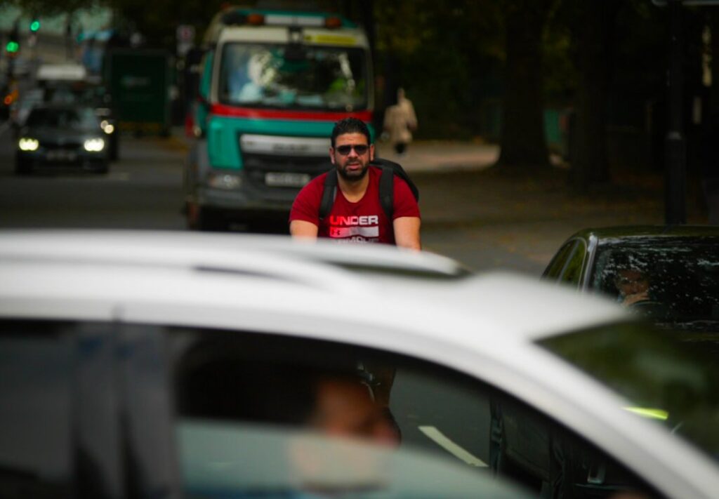 Cyclist in traffic (copyright Simon MacMichael)