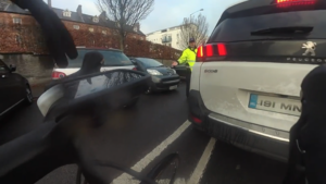 Traffic warden blocks bike lane