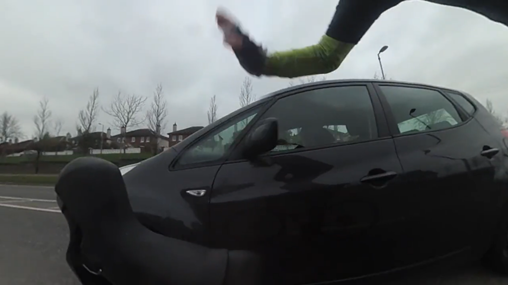 Cyclist slaps wing mirror after close pass