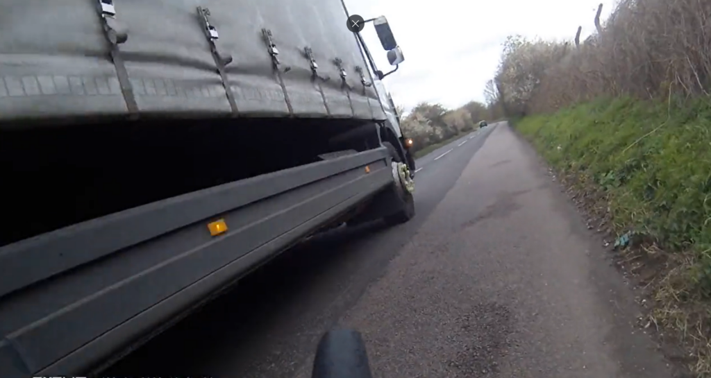 Lorry driver nearly hits cyclist while overtaking tractor