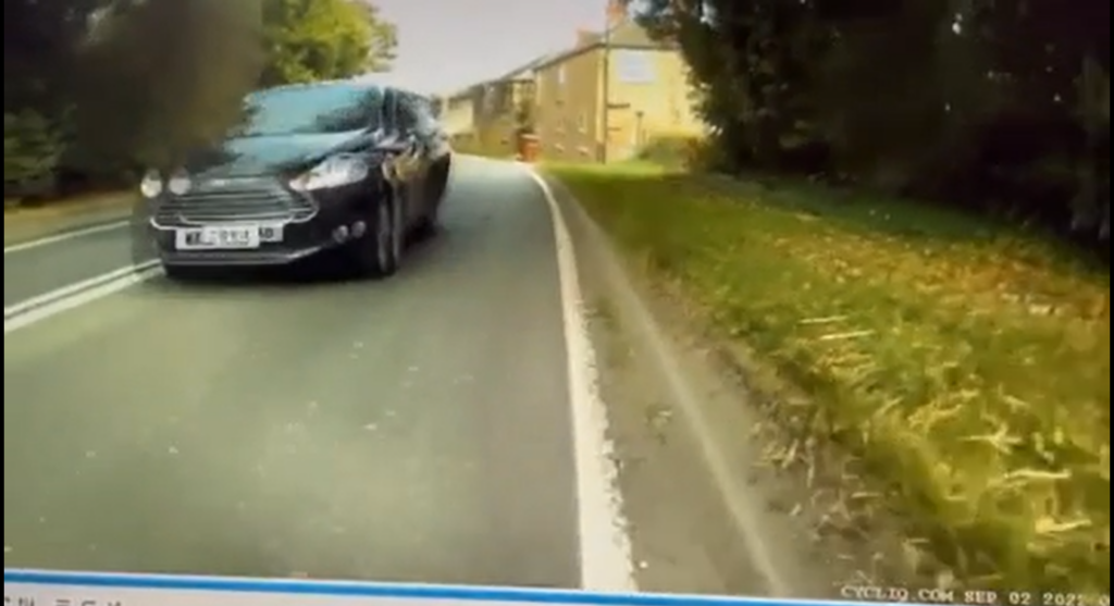 Reckless moment passenger hits cyclist by opening car door as driver overtakes
