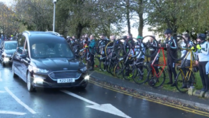 Local cyclists form a guard of honour at funeral of Brian Robinson (screenshot, ITV News)