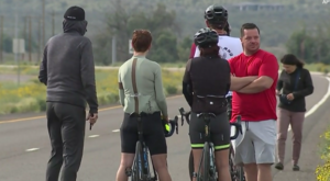 Cyclists wait near scene of collision involving group of riders and pickup truck driver in Arizona