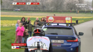 Tadej Pogacar receives a helping hand from the race director’s car at Amstel Gold, 2023