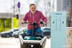 Cargo e-bike cyclist with SolarPoint charging pillar