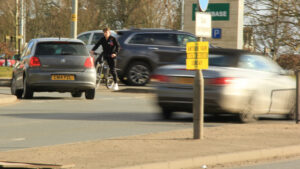 Cyclist crossing Dereham Road, Norwich