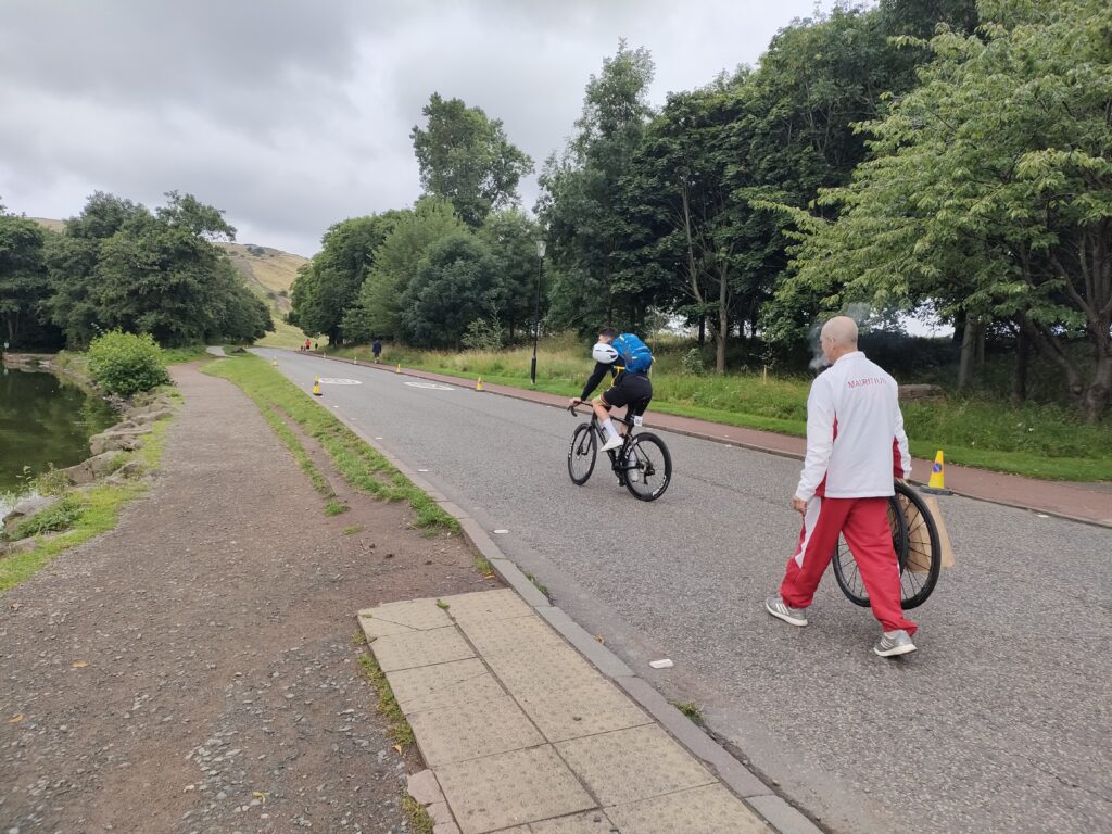 The Mauritius rider and soigneur make their way to the start of the 2023 men&rsquo;s elite world road race championships in Edinburgh (Ryan Mallon)