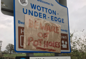 Pothole warning on town sign in Wotton-Under-Edge, Gloucestershire (Rachel, Twitter