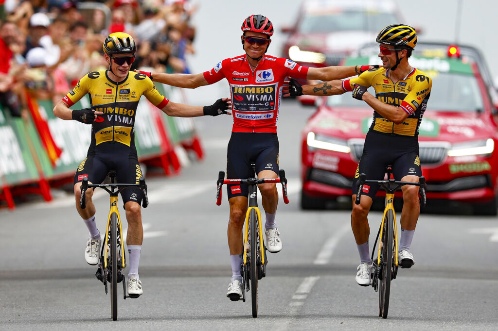 Sepp Kuss, Jonas Vingegaard, and Primož Roglič cross the line together on stage 20 of the 2023 Vuelta a España