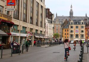 Cyclists in Lille’s Grand’Place (licensed CC BY SA 2.0 by Alain Rouiller on Flickr)
